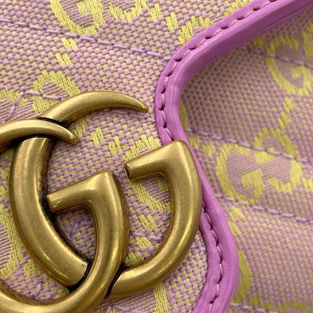 Close-up of GUCCI Pre-Loved GG Super Mini Canvas bag featuring signature logo and vibrant color detail