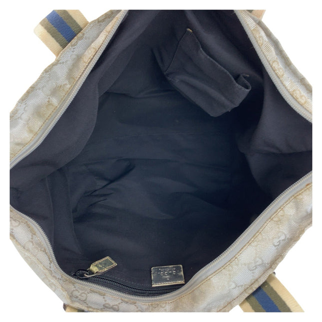 Interior view of a GUCCI pre-owned bag showing black lining and compartments for organizing items