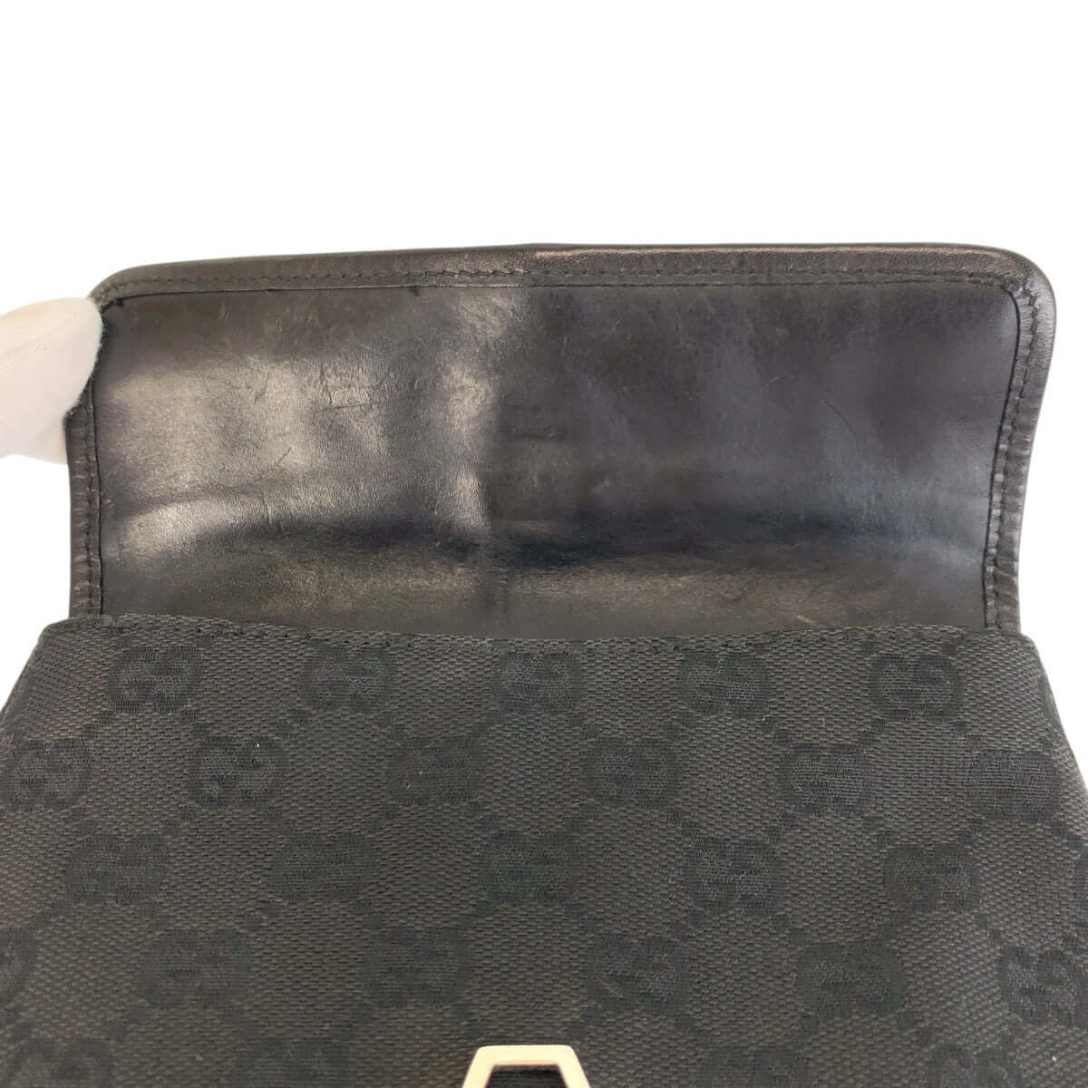 GUCCI Pre-owned bag interior featuring iconic logo pattern and premium craftsmanship
