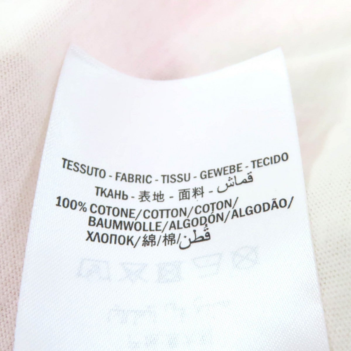Label of a pre-owned Gucci t-shirt showing fabric composition and care instructions