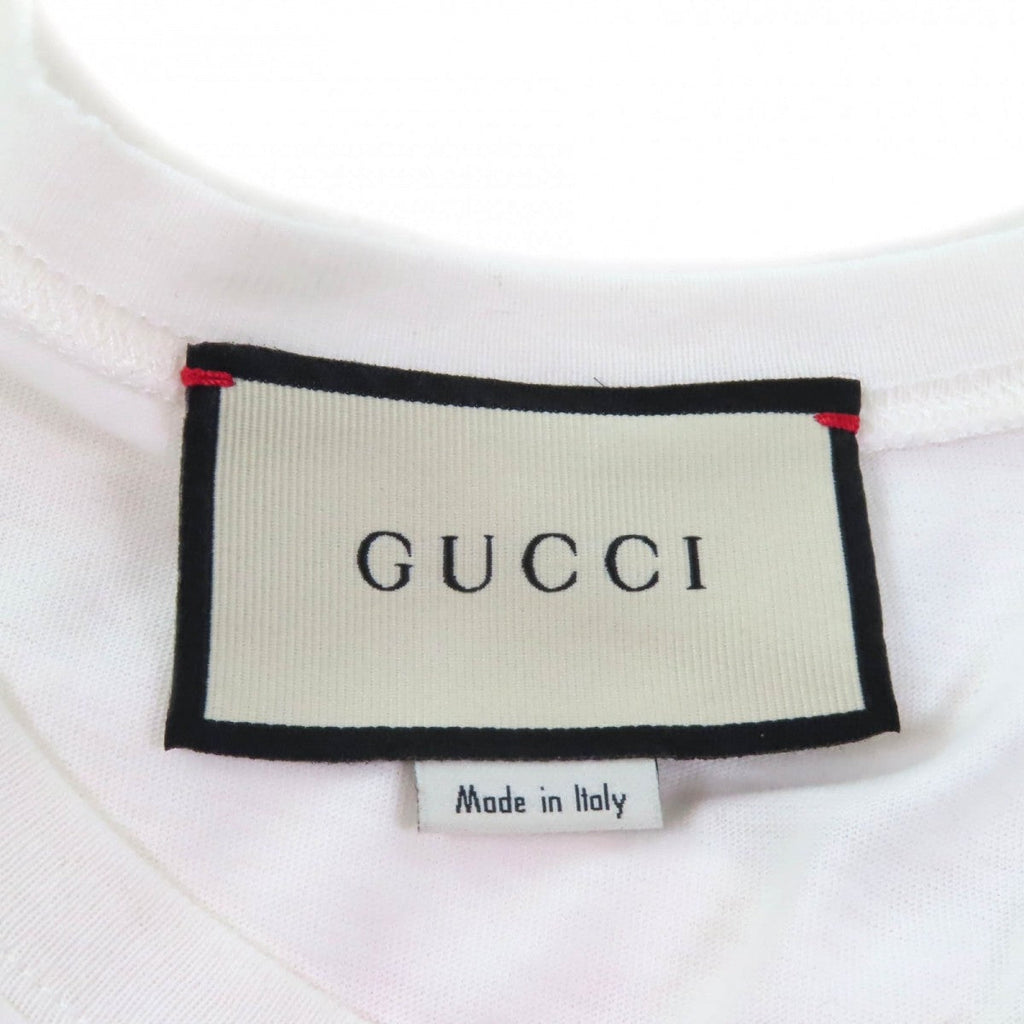 Label of a pre-owned Gucci t-shirt showcasing the brand name and Made in Italy detail