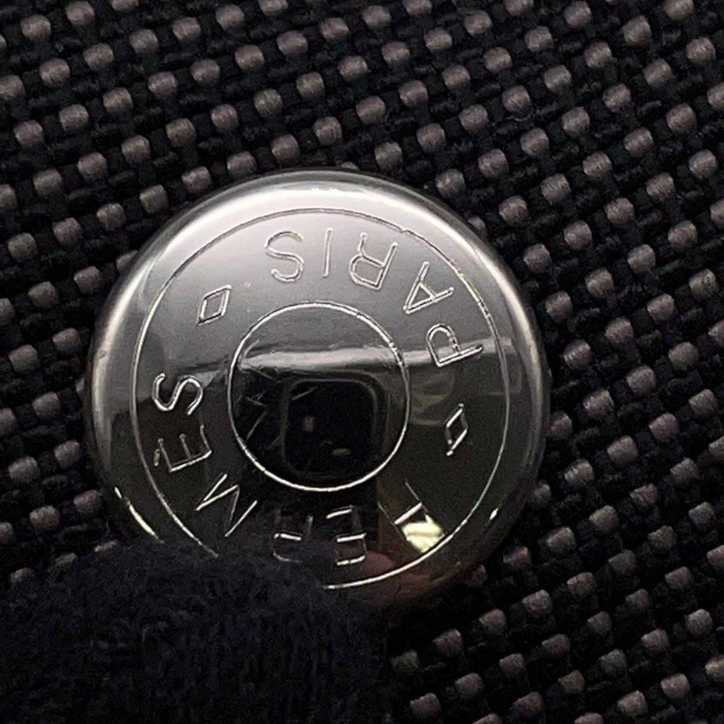 Hermès Pre-Loved Air Line PM Tote Bag featuring a signature circular logo detail on a textured fabric