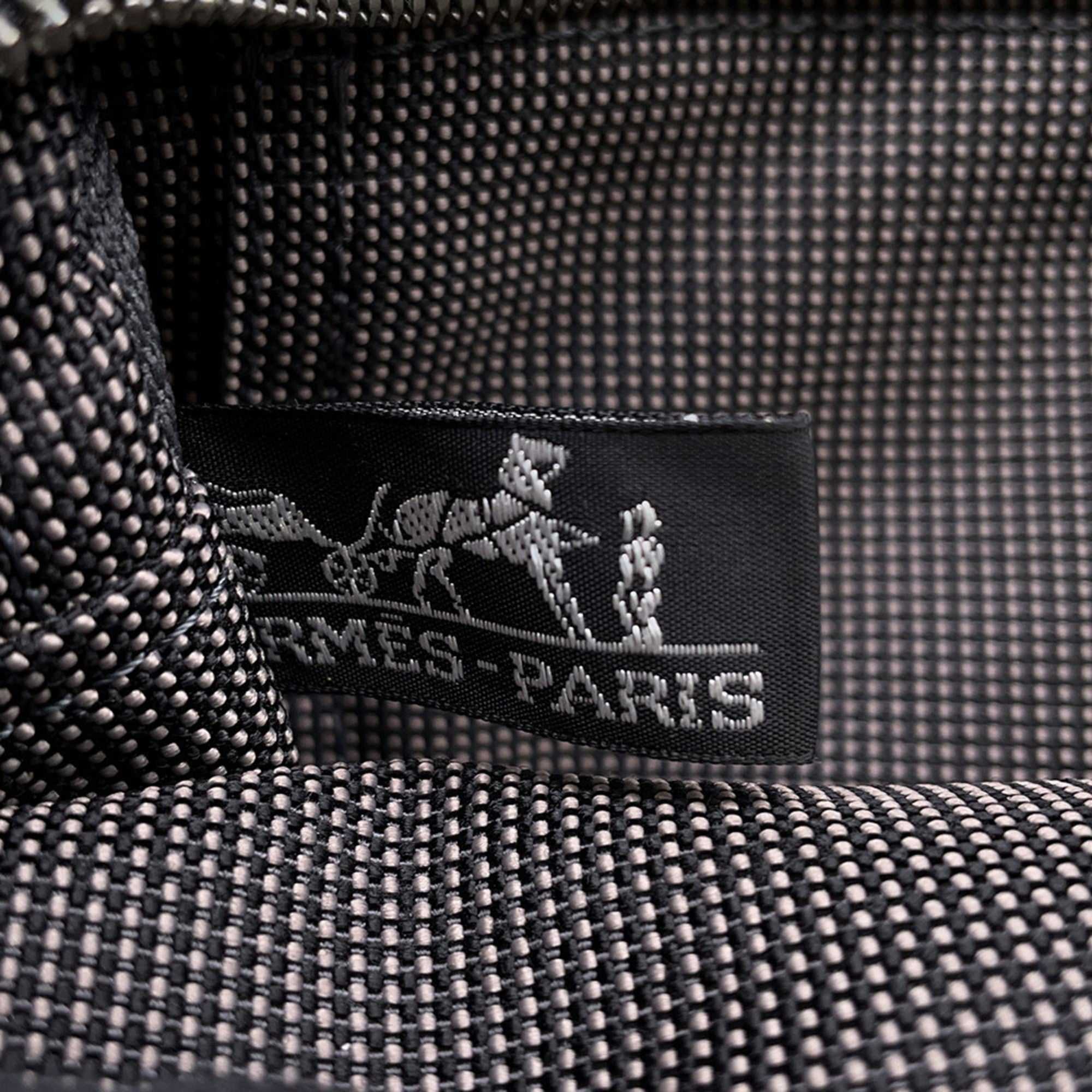 Interior label of Hermès Pre-Loved Air Line PM Tote Bag with black and gray patterned lining