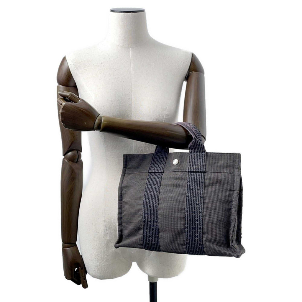 MANSII Hermès Pre-Loved Air Line PM Tote Bag in gray with sturdy handles and subtle logo design