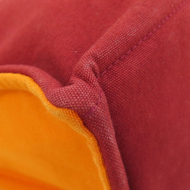 Pre-owned Hermes bag with rich burgundy exterior and vibrant orange lining for stylish storage