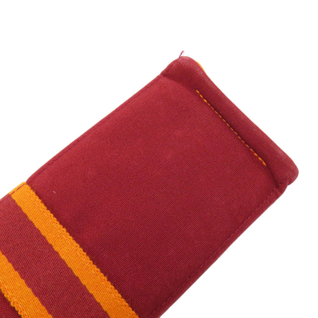 Pre-owned Hermes bag with a rich maroon fabric and bold striped accents for stylish everyday use