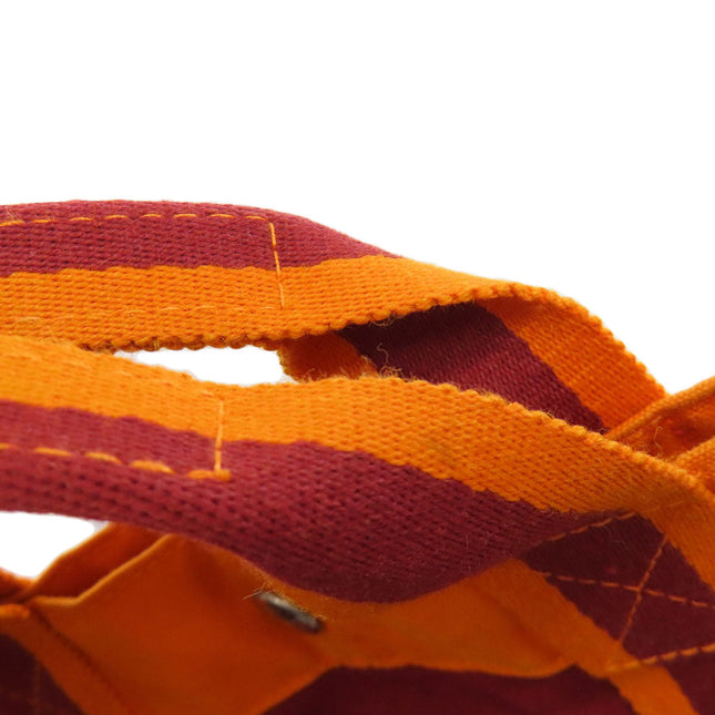 Hermes pre-owned bag featuring vibrant orange and red striped straps for a stylish look