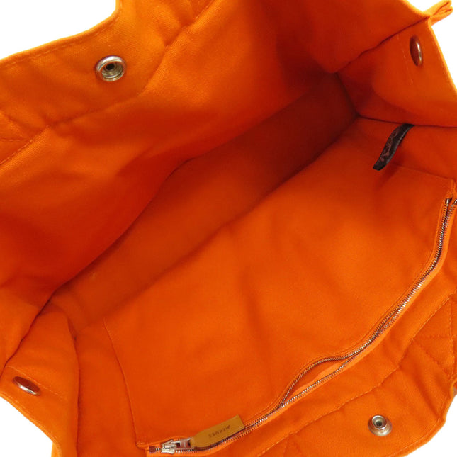 Interior view of pre-owned Hermes bag with vibrant orange lining and zip pocket