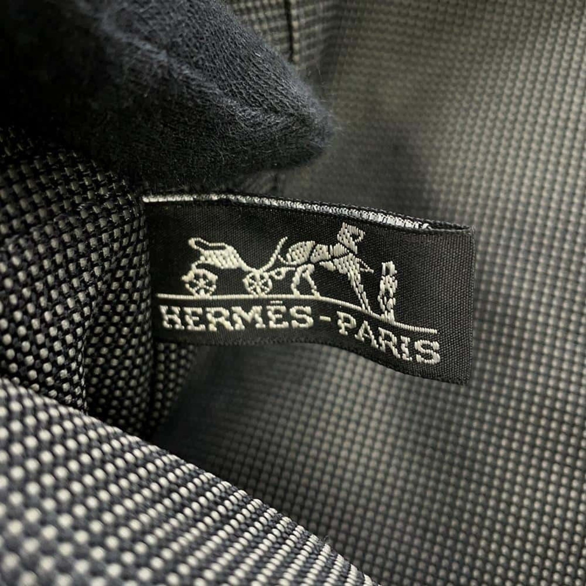 Close-up of Hermes pre-owned bag label showcasing the iconic logo and fine craftsmanship