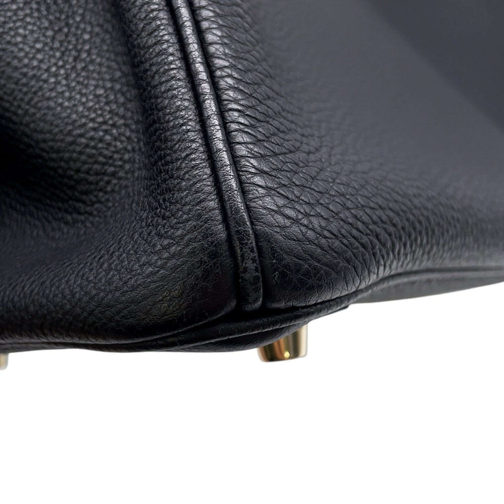 Detail of a pre-owned Hermès Birkin 30 in black leather showcasing its textured surface and gold hardware