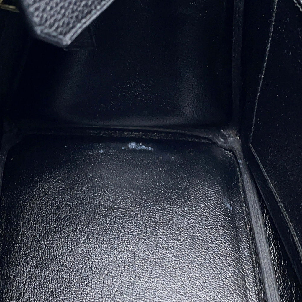 Interior view of a pre-owned Hermès Birkin 30 with black leather lining and elegant craftsmanship