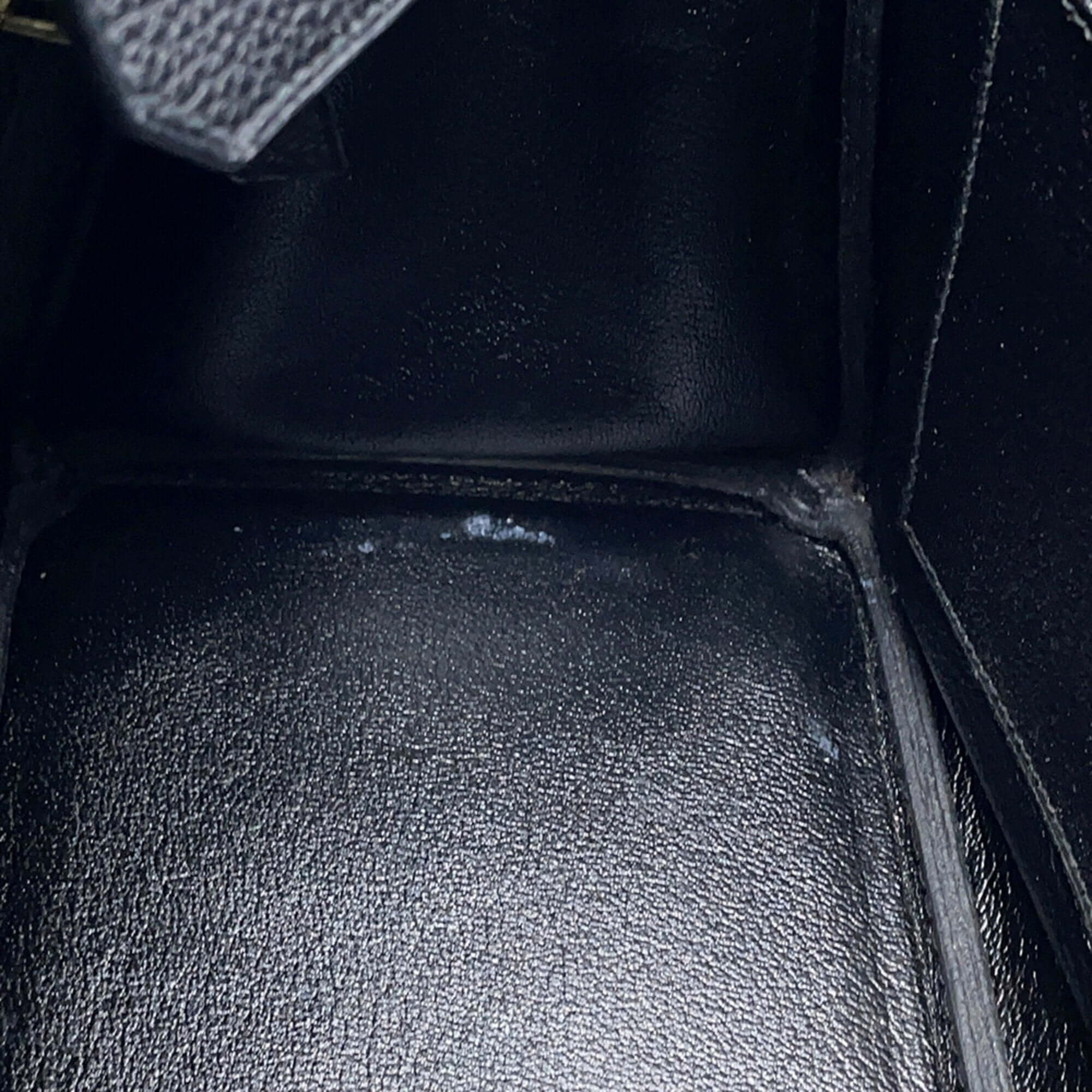 Interior view of a pre-owned Hermès Birkin 30 with black leather lining and elegant craftsmanship