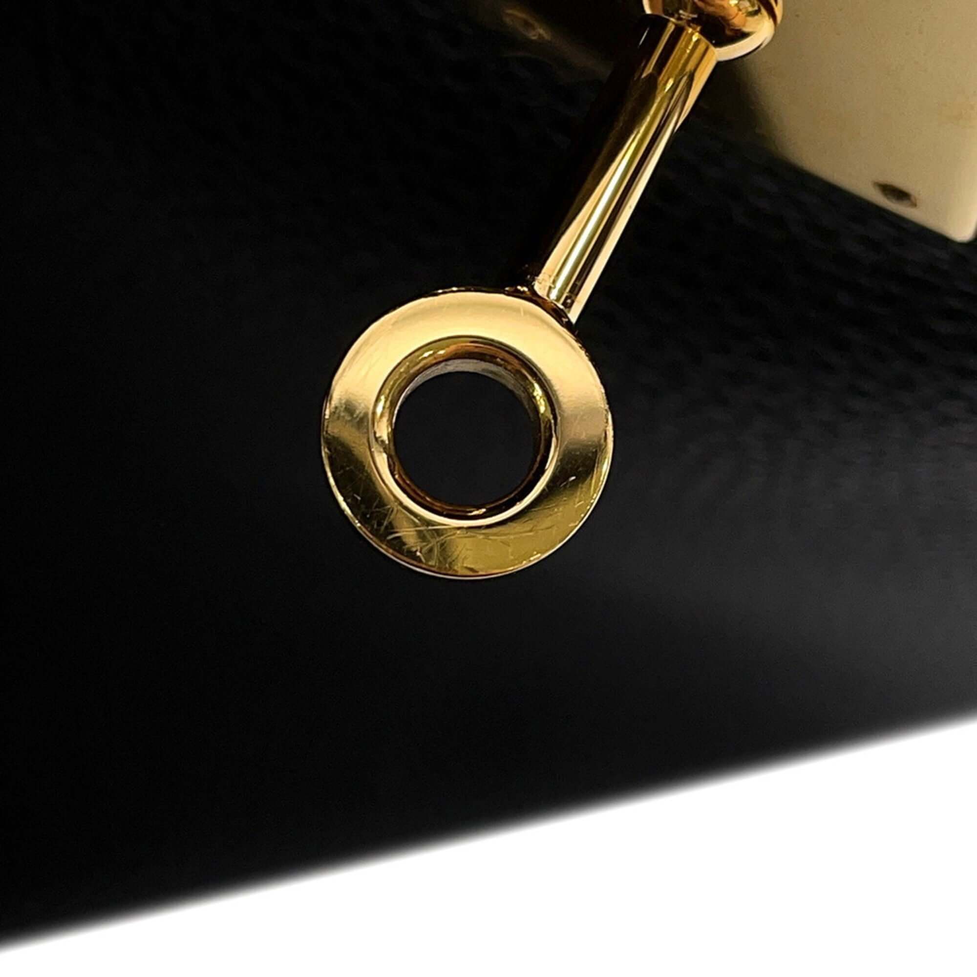 Close-up of the gold hardware on a pre-owned Hermès Birkin 30 handbag, showcasing its luxury details