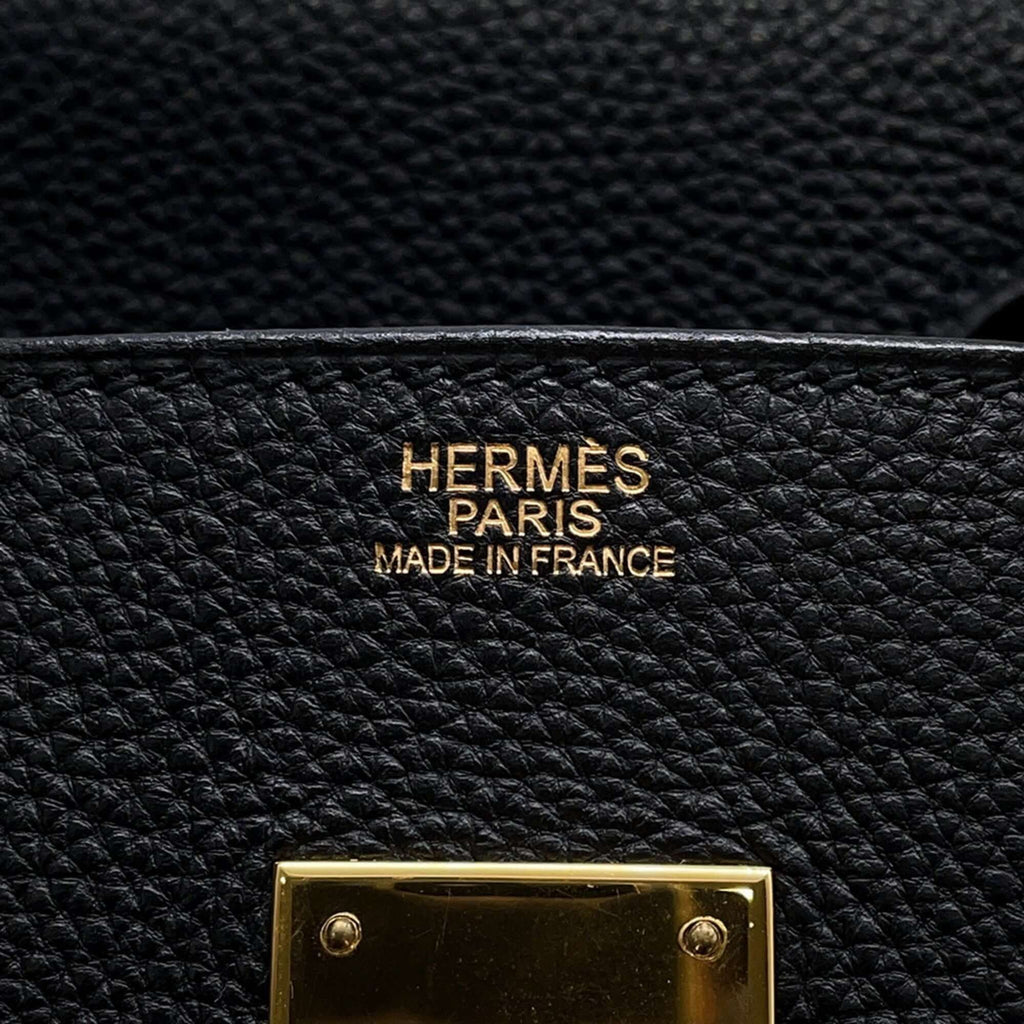 Interior label of a pre-owned Hermès Birkin 30 bag featuring gold lettering and craftsmanship details