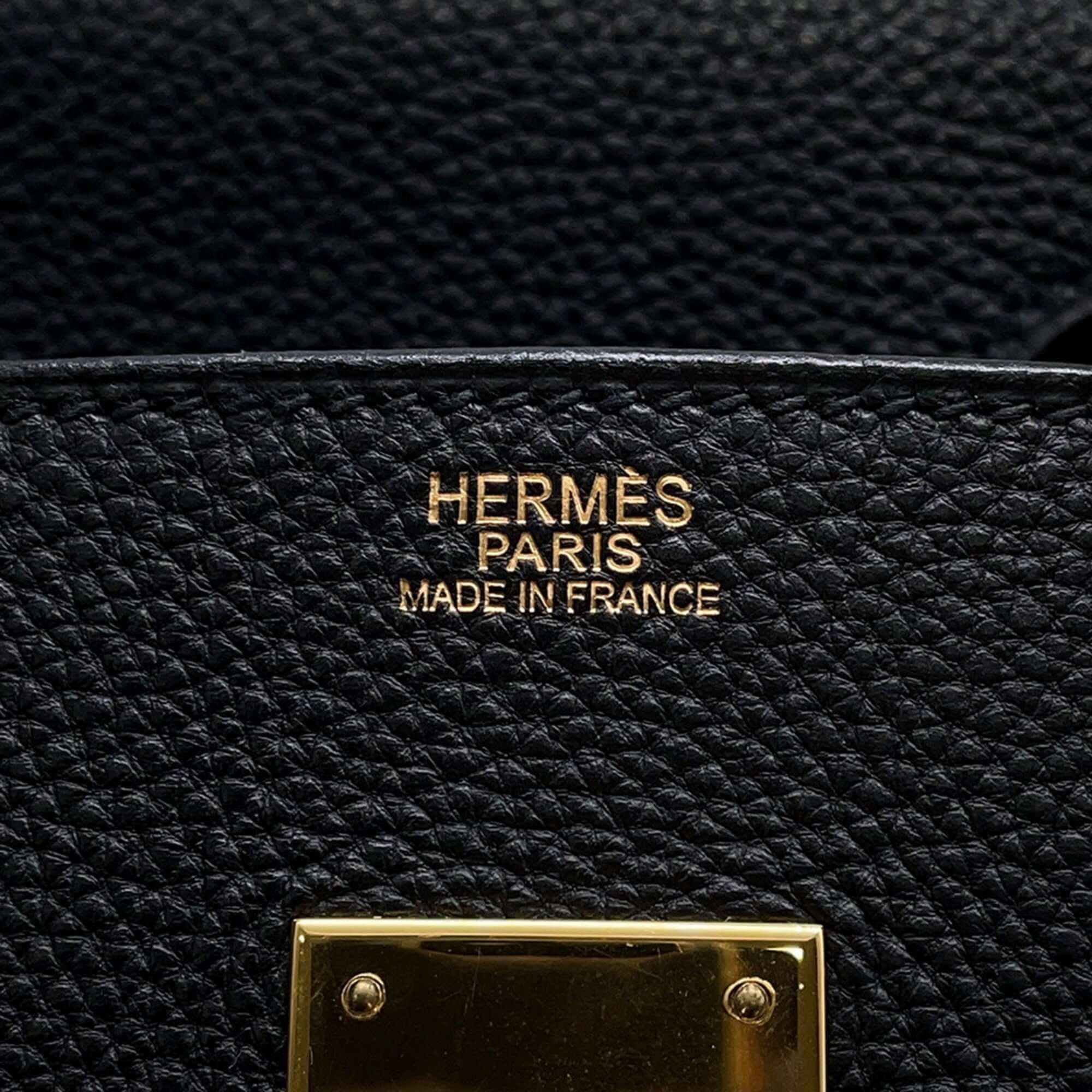 Interior label of a pre-owned Hermès Birkin 30 bag featuring gold lettering and craftsmanship details