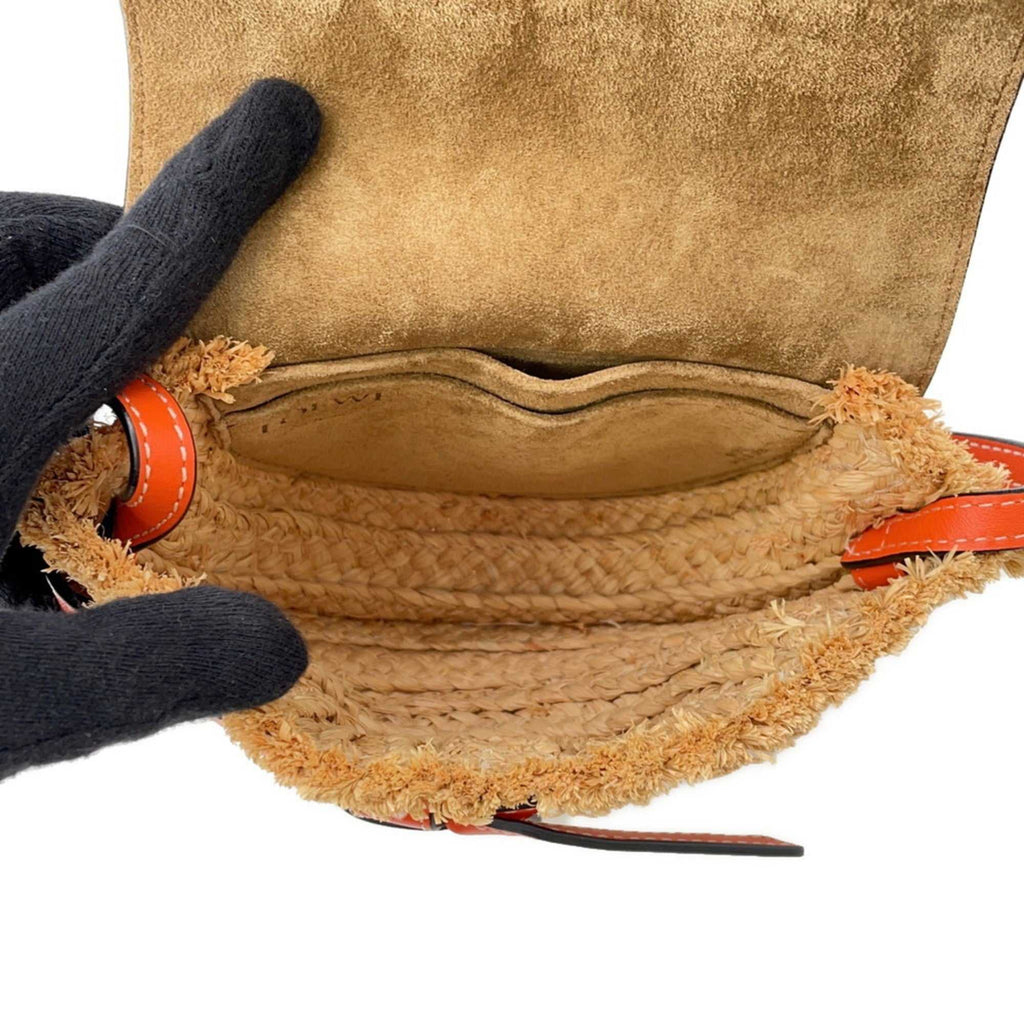 Interior view of the MANSII LOEWE Pre-Loved Gate Mini Raffia Bag featuring a cozy suede lining and woven details