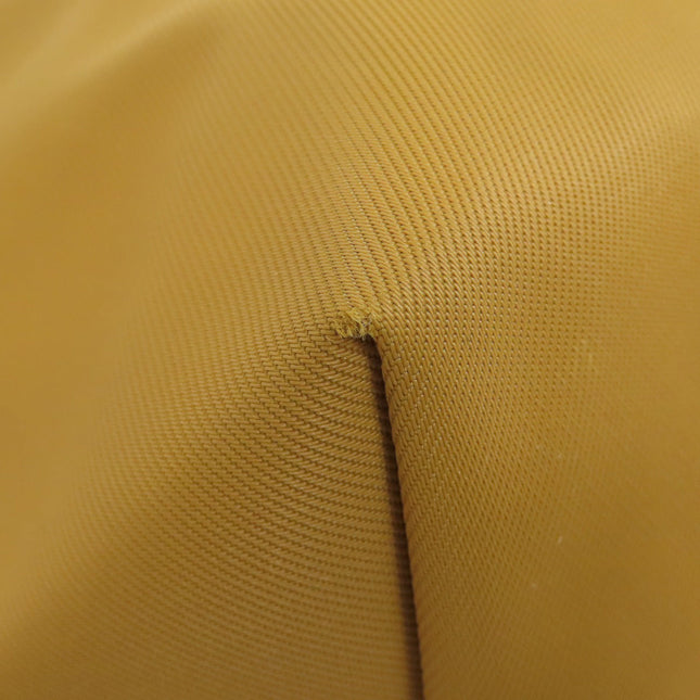 Close-up of a pre-owned Longchamp bag showcasing yellow fabric texture and stitching details