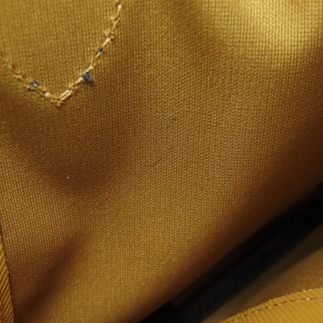 Longchamp pre-owned bag interior lining in vibrant yellow with detailed stitching pattern