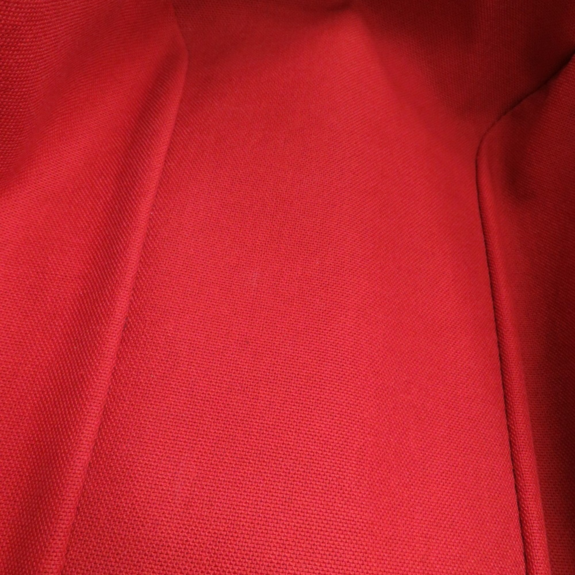 Interior view of an authentic Louis Vuitton Belem MM bag for sale with vibrant red lining