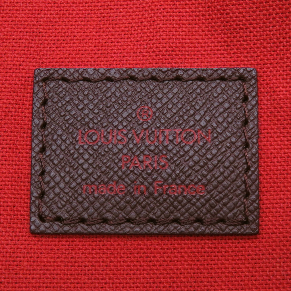 Authentic Louis Vuitton Belem MM bag for sale featuring a red canvas interior and embossed logo patch