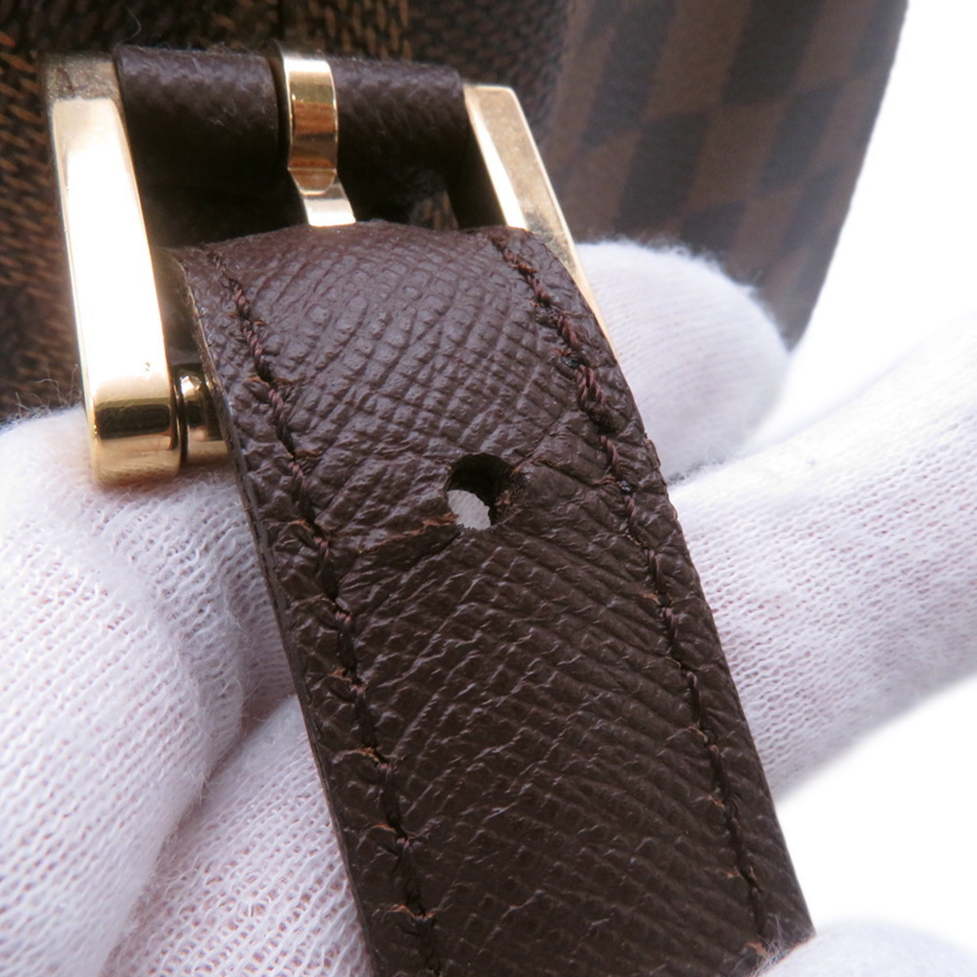 Close-up of the strap detail showcasing the buckle of the authentic Louis Vuitton Belem MM bag for sale