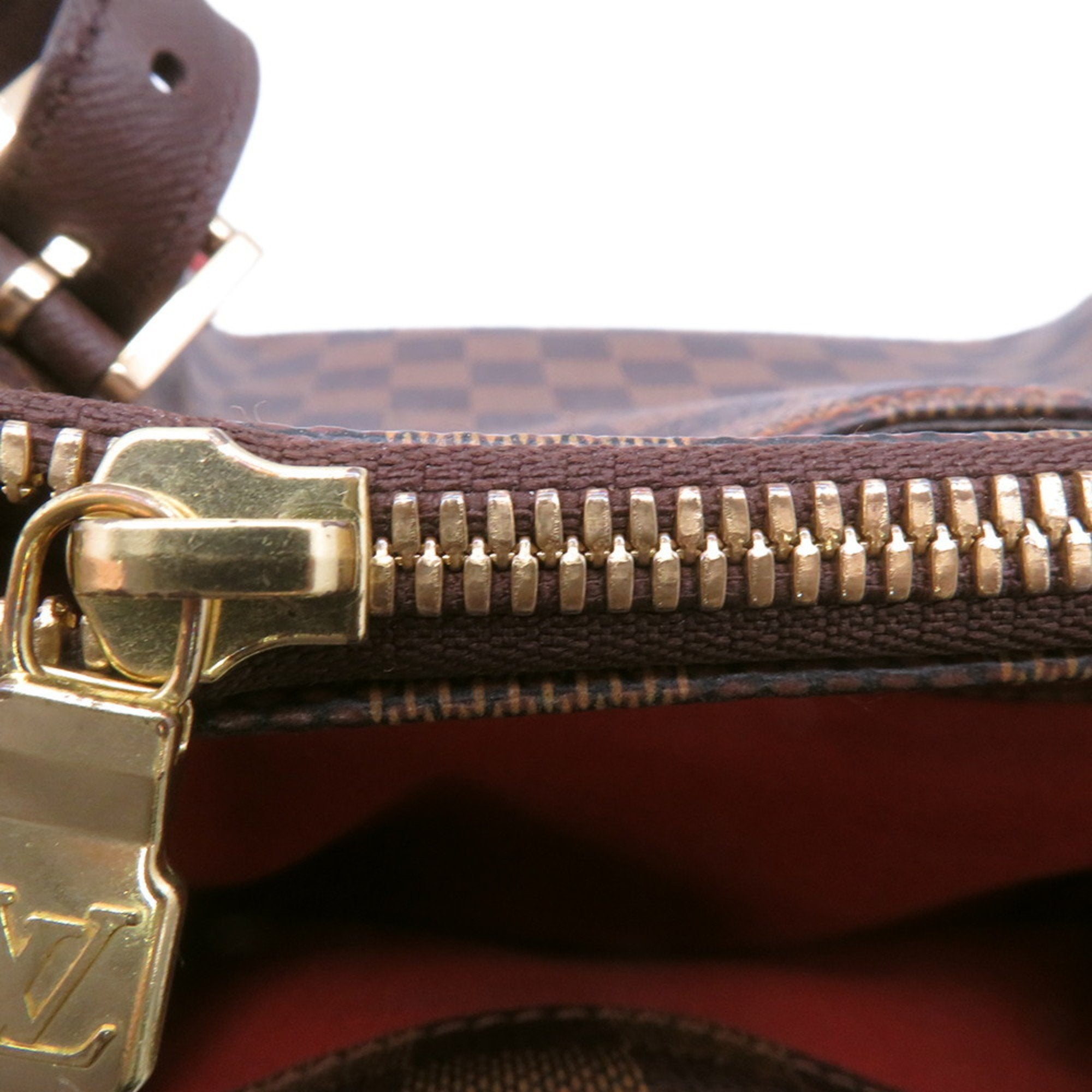 Close-up of the zipper detail on an authentic Louis Vuitton Belem MM bag for sale