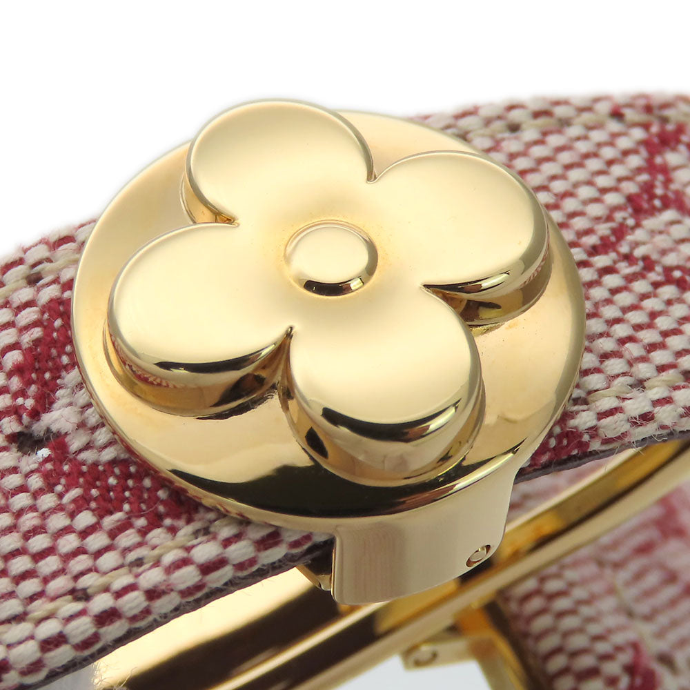 Authentic secondhand Louis Vuitton jewelry with a gold flower clasp design and red fabric band