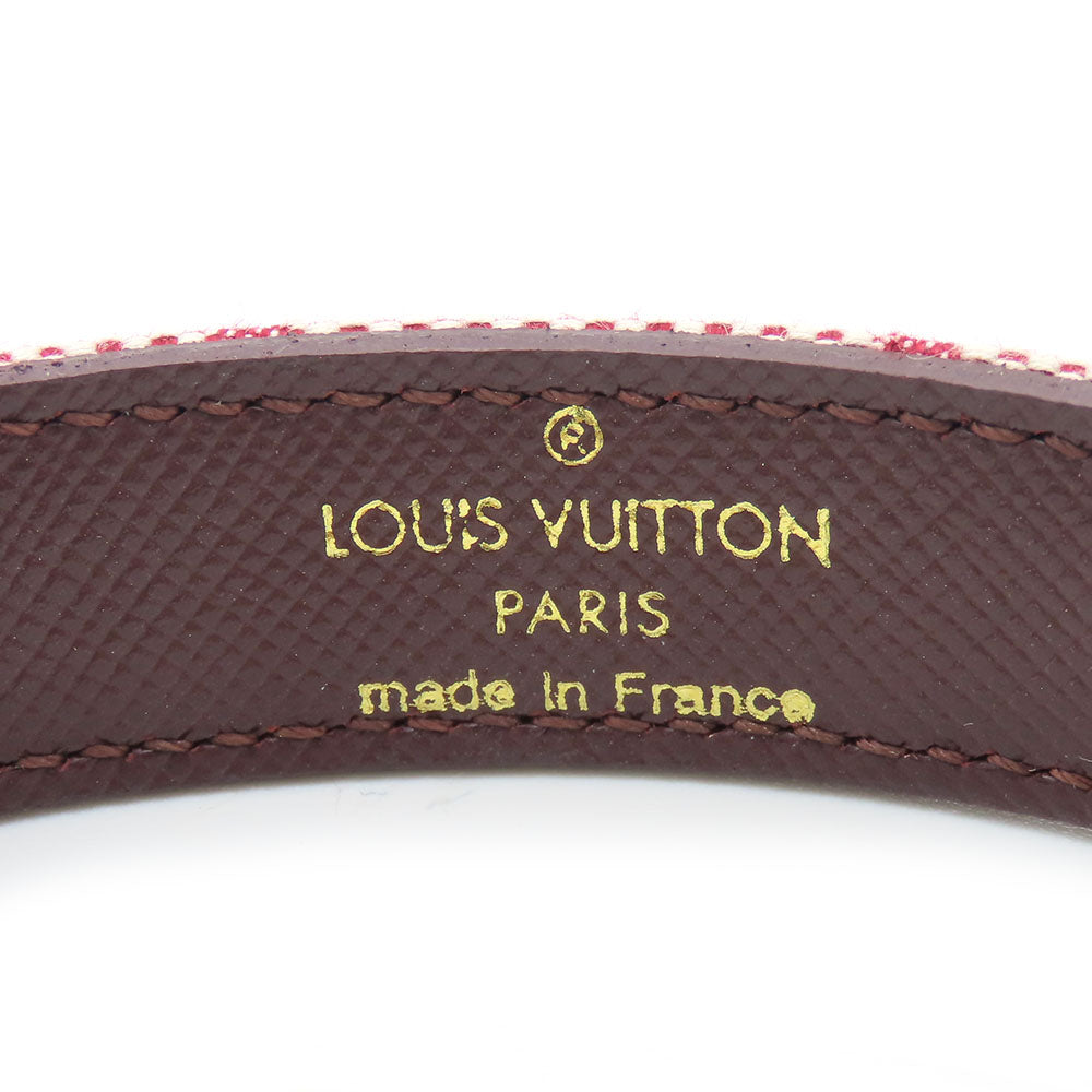 Close-up of authentic secondhand Louis Vuitton jewelry showing detailed logo and craftsmanship