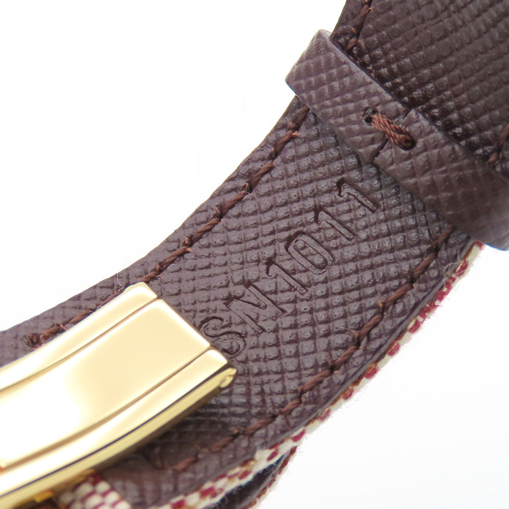 Close-up of authentic secondhand Louis Vuitton jewelry featuring a gold clasp and textured strap