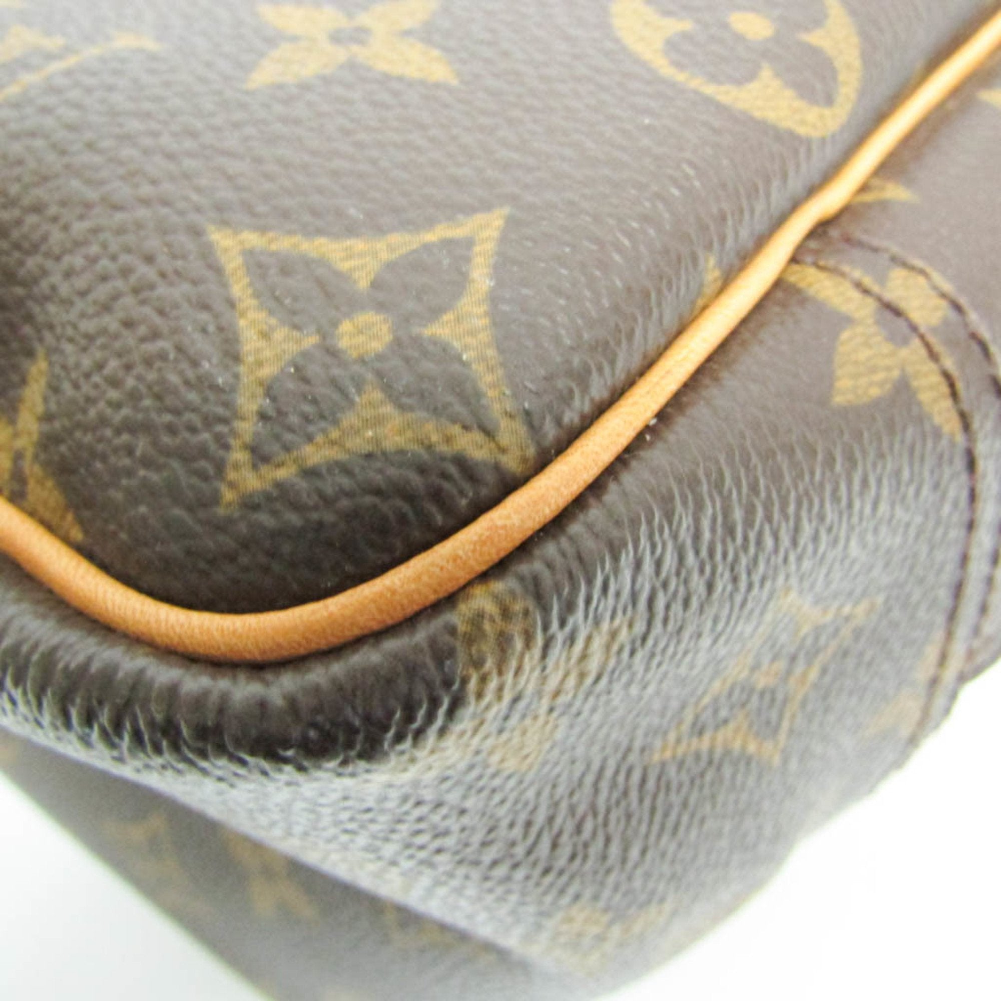 Close-up of LOUIS VUITTON pre loved Deauville bag featuring iconic monogram design and smooth leather finish