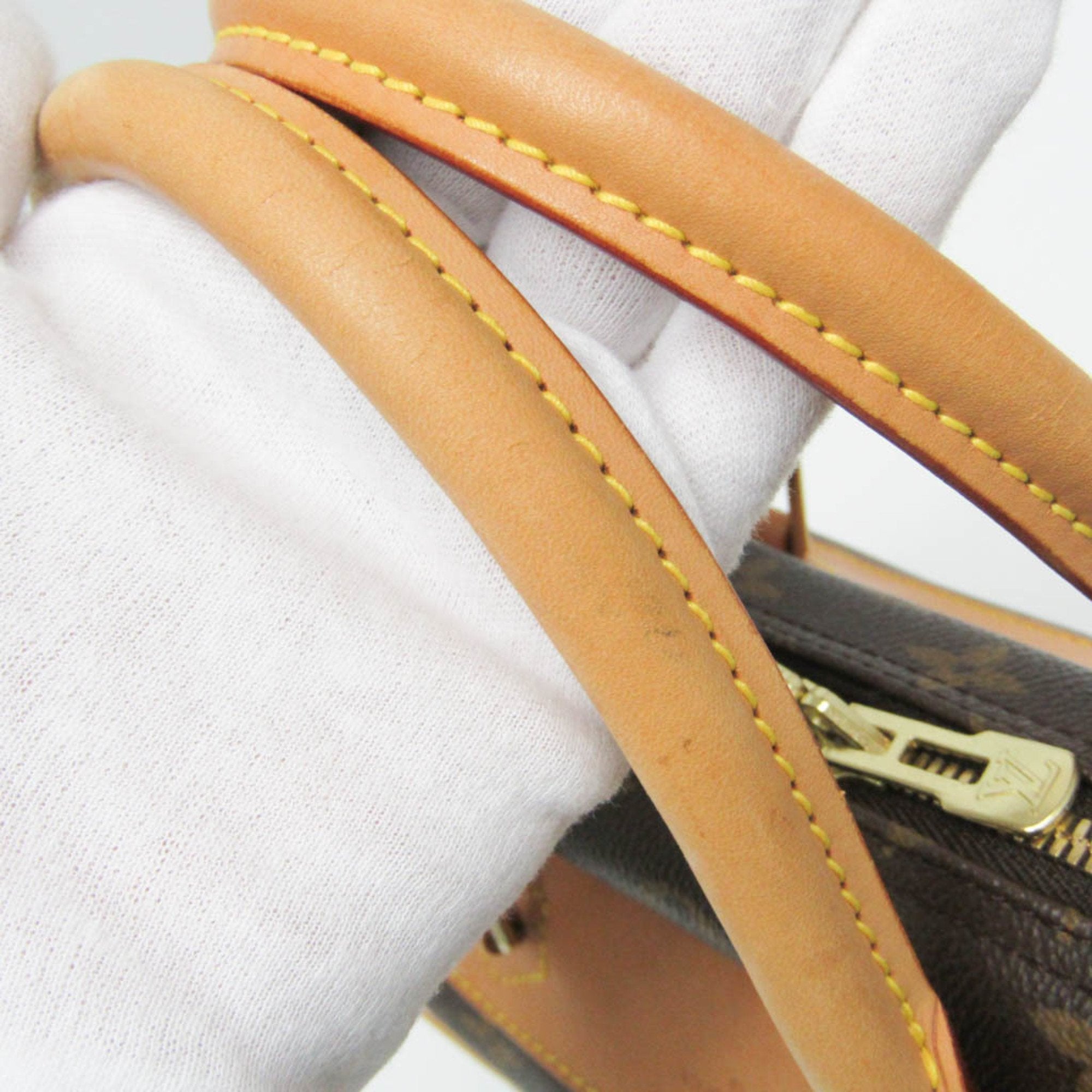 Close-up of LOUIS VUITTON pre loved Deauville bag strap highlighting its premium craftsmanship