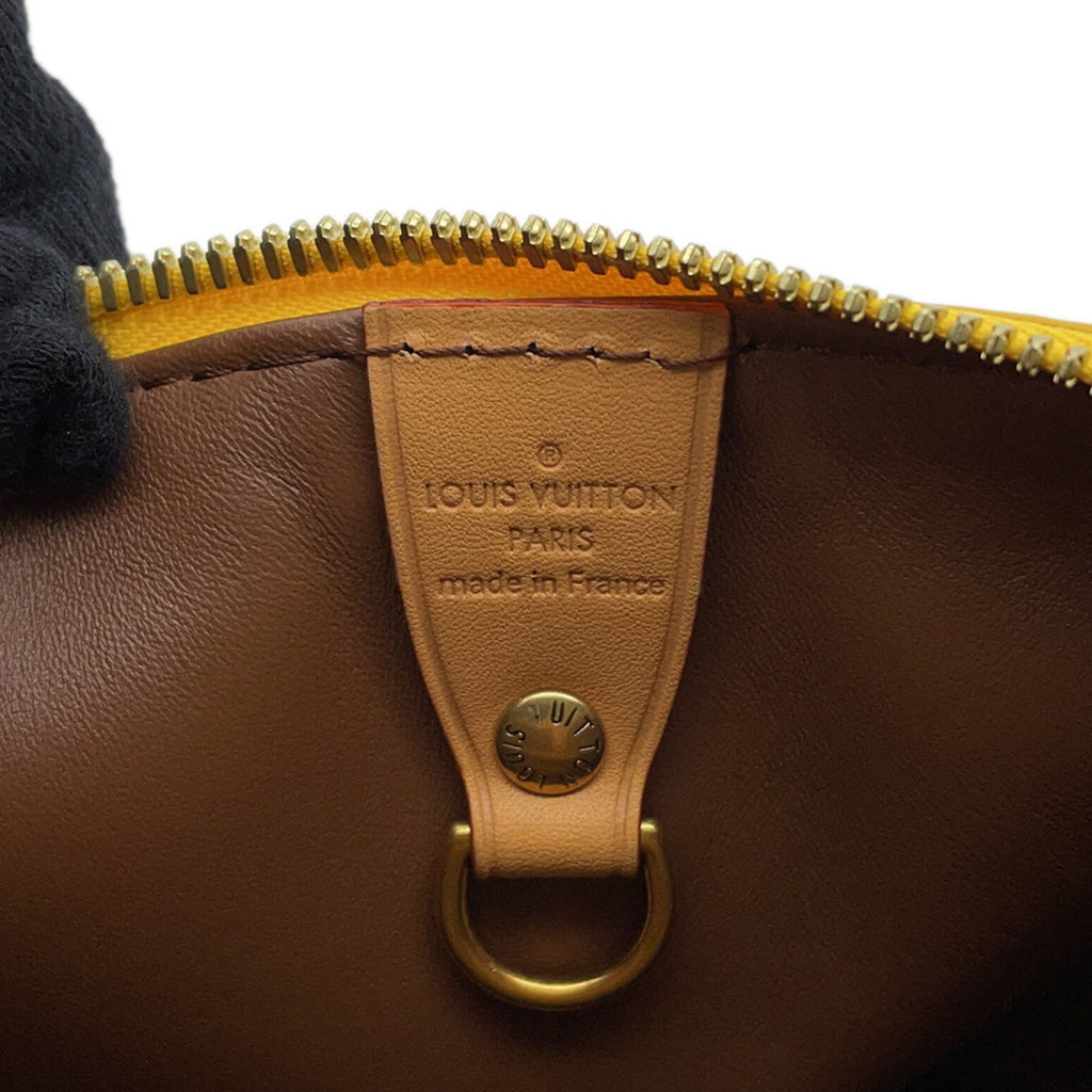 Interior of a MANSII pre-loved Louis Vuitton bag showcasing the brand tag and zipper details