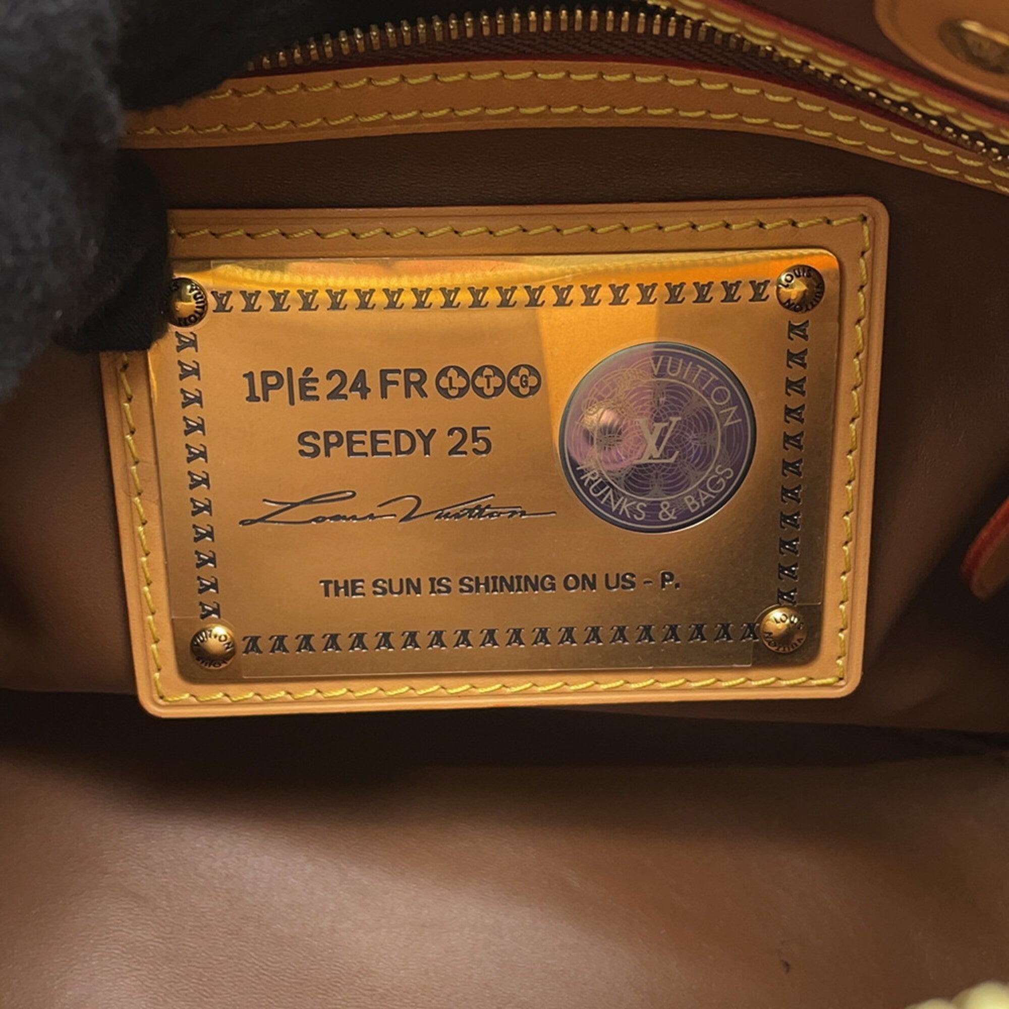 Inside label of a MANSII pre-loved Louis Vuitton Speedy 25 bag showing authentic details