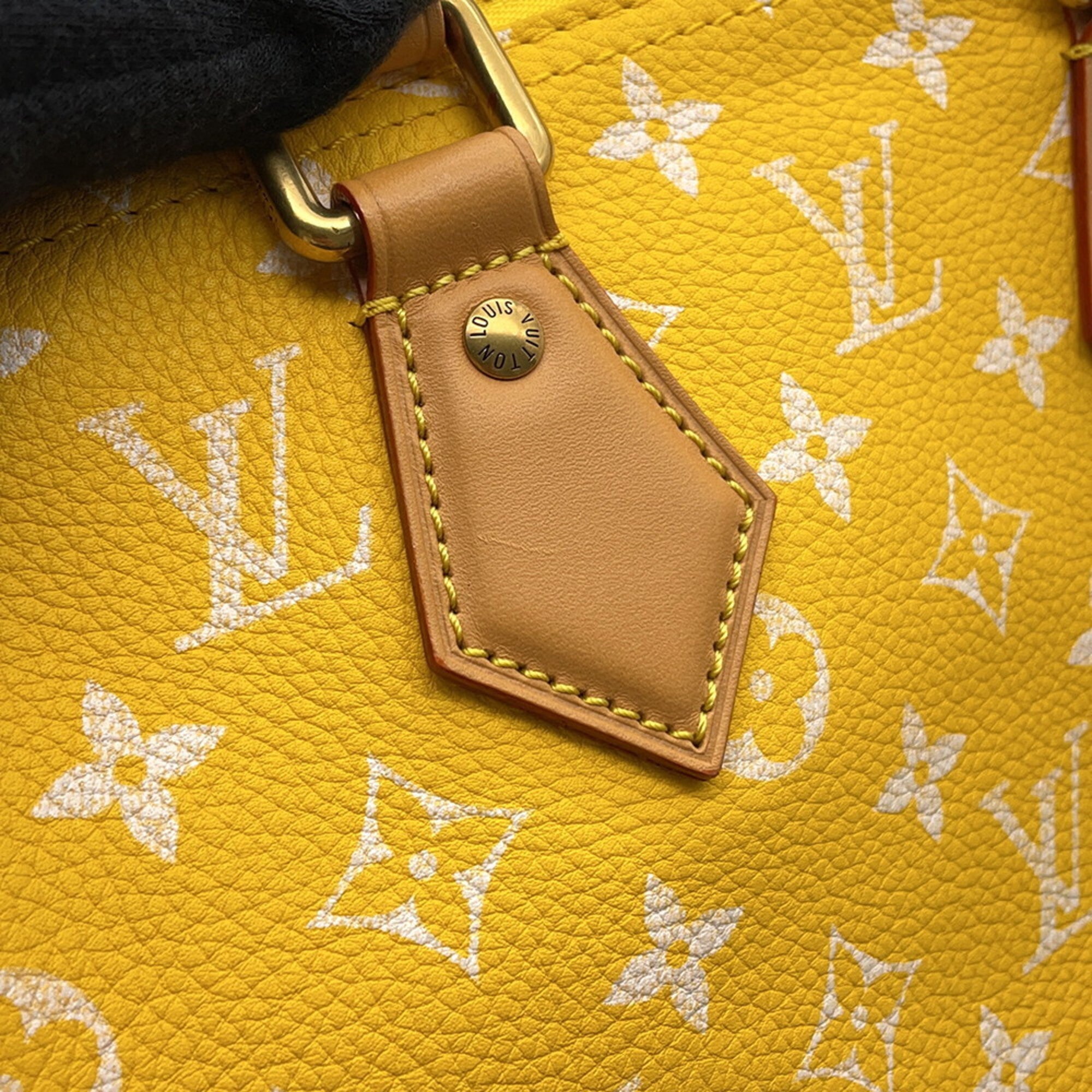 Close-up of a Pre-loved Louis Vuitton handbag featuring a vibrant yellow leather and iconic monogram design