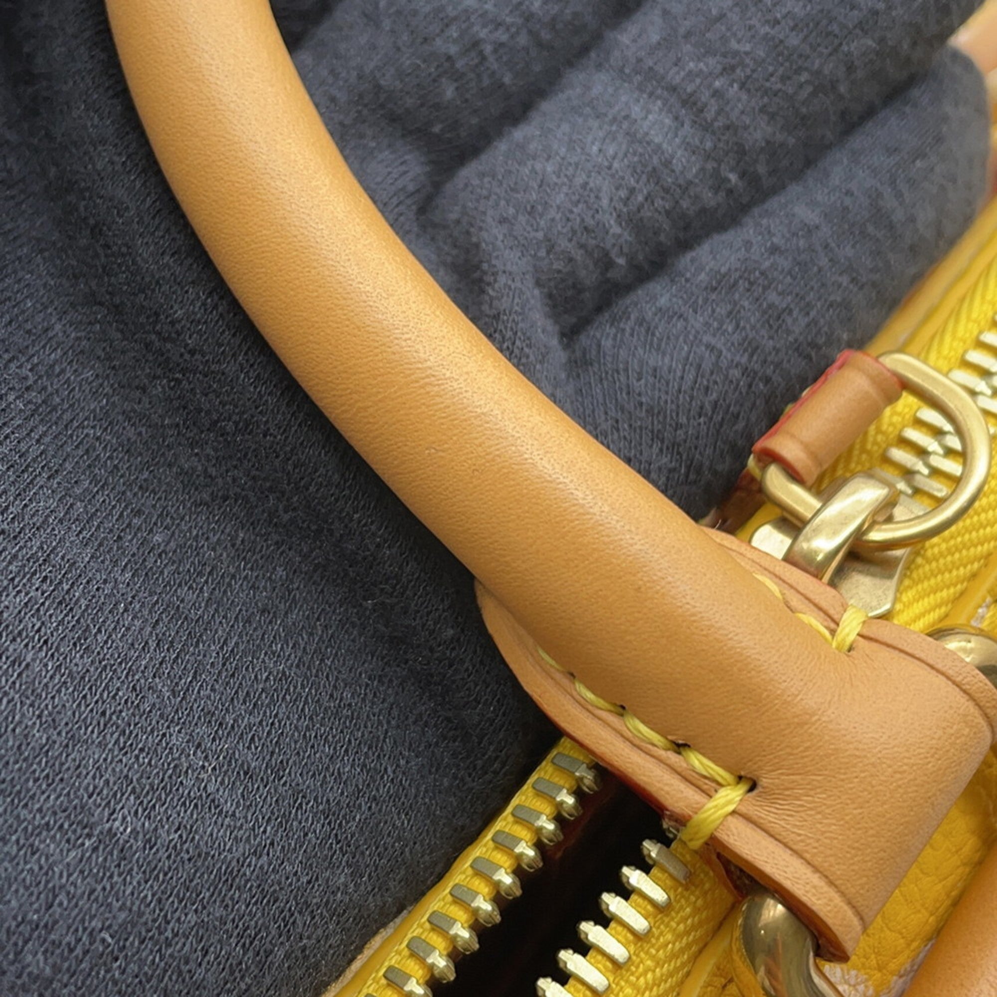 Close-up of a MANSII handbag handle showcasing pre-loved leather craftsmanship and quality stitching