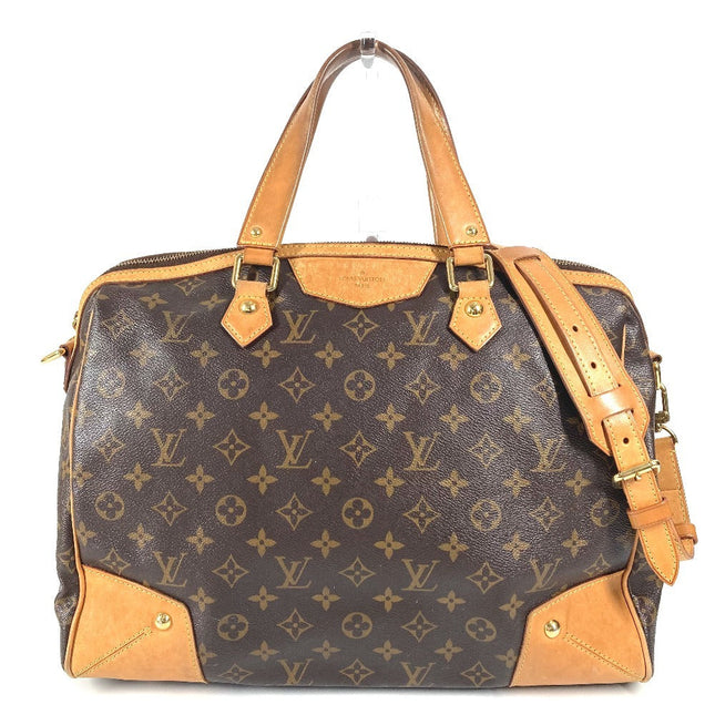 Louis Vuitton pre-owned handbag in monogram canvas with leather accents and top handles
