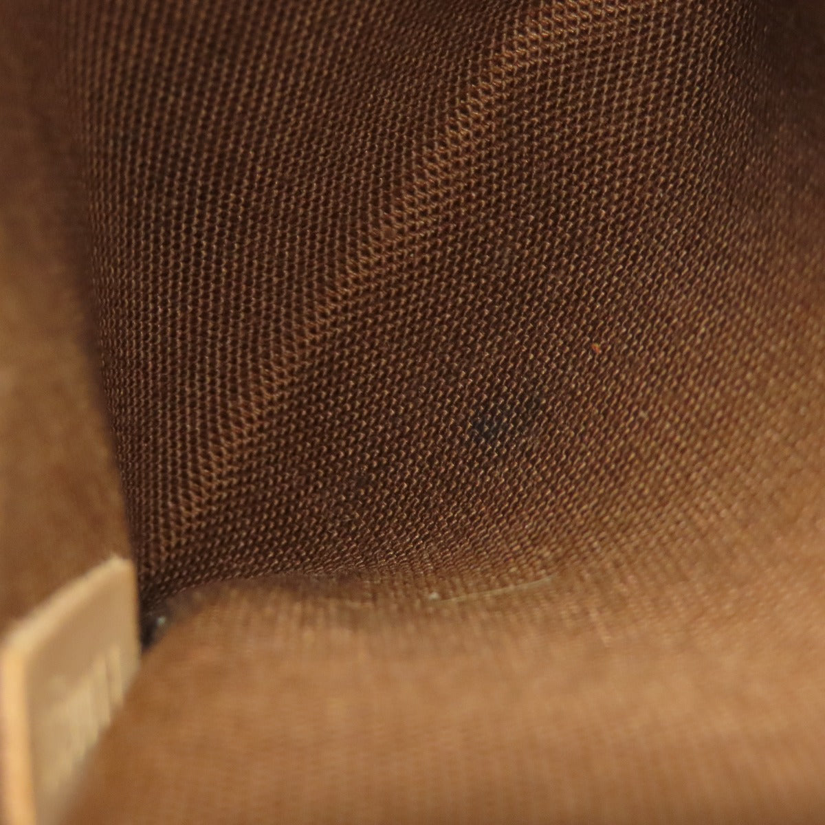 Interior view of a pre-owned Louis Vuitton bag showcasing brown fabric lining