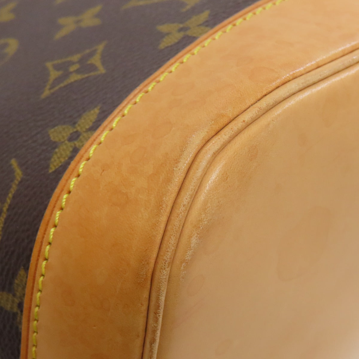 Close-up of a pre-owned Louis Vuitton bag showcasing the leather details and signature pattern