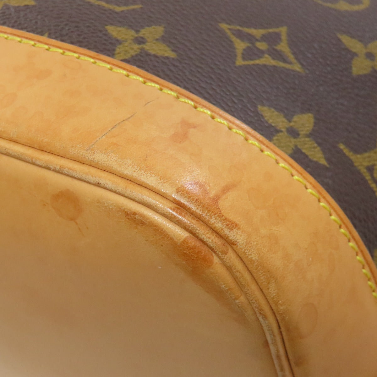 Pre-owned Louis Vuitton bag showing authentic patina on the leather trim for classic style