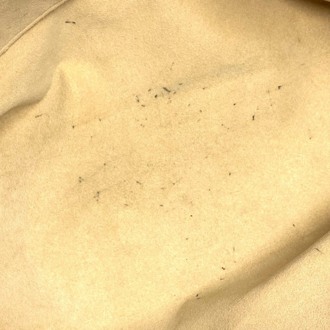 Close-up of a pre-owned Louis Vuitton bag showing minor wear marks on the interior fabric