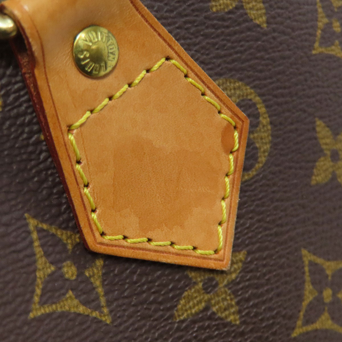 Close-up of a pre-owned Louis Vuitton bag showing the signature monogram and stitching detail