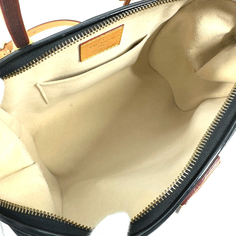 Interior of a pre-owned Louis Vuitton bag with beige lining and zipper pockets for added organization