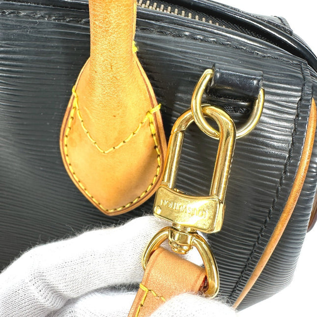 Close-up of a pre-owned Louis Vuitton bag featuring a signature monogram strap and gold hardware