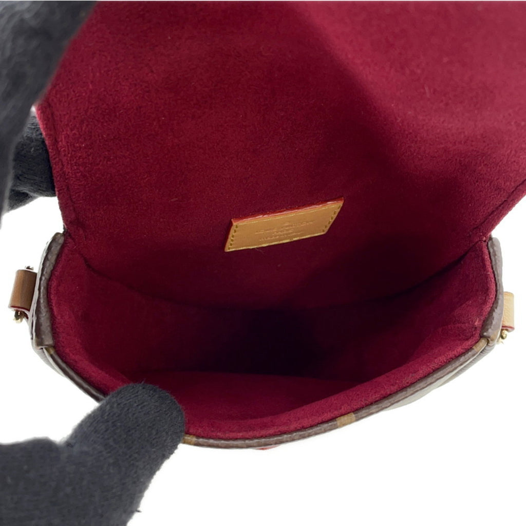 Interior view of the pre-owned Louis Vuitton Chantilly bag featuring rich burgundy lining