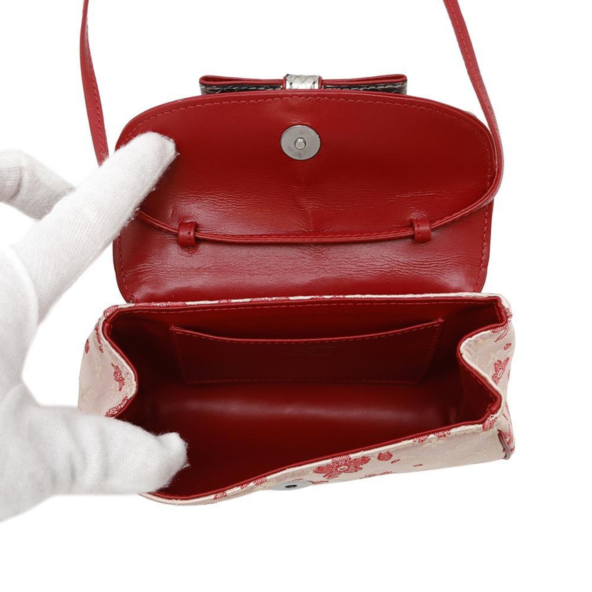 Louis Vuitton pre-owned bag with floral design and red interior, showing inside compartments