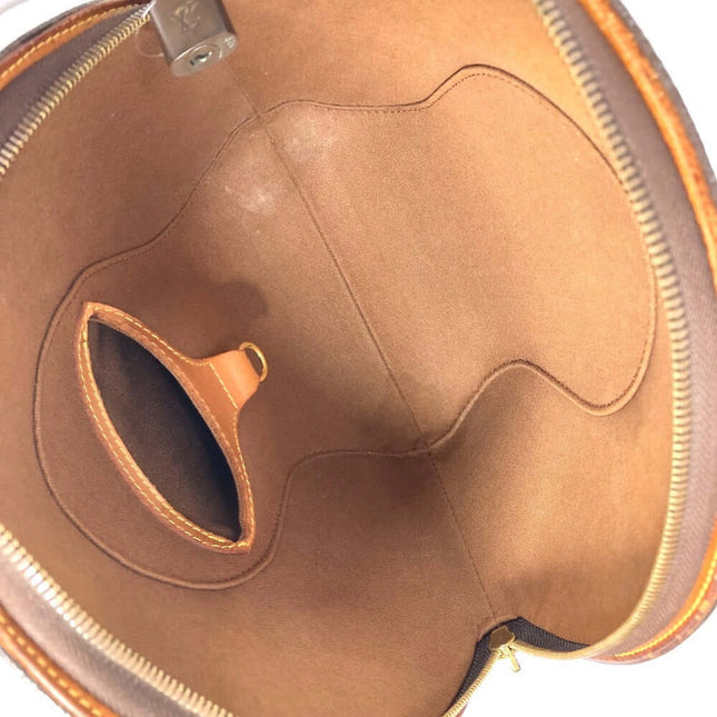 Interior of a pre-owned Louis Vuitton bag featuring suede lining and zippered pocket compartments