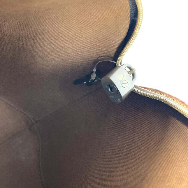 Interior view of a LOUIS VUITTON bag featuring a lock, pre-owned luxury condition