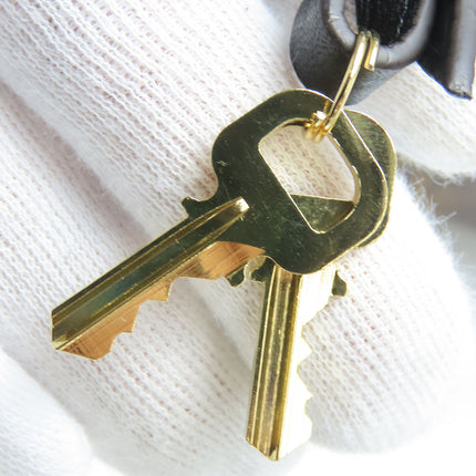 Pre-Owned Louis Vuitton handbag showcasing golden keychain with dual keys for added style