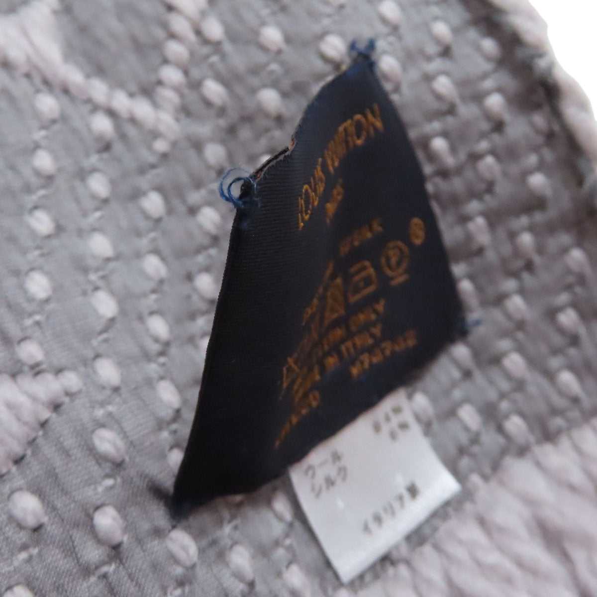 Pre-owned Louis Vuitton wool scarf label showing brand and care details for quality assurance