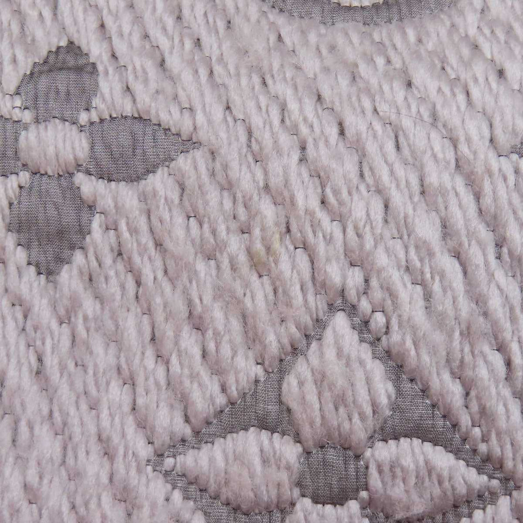 Close-up detail of a pre-owned Louis Vuitton wool scarf featuring the iconic monogram pattern